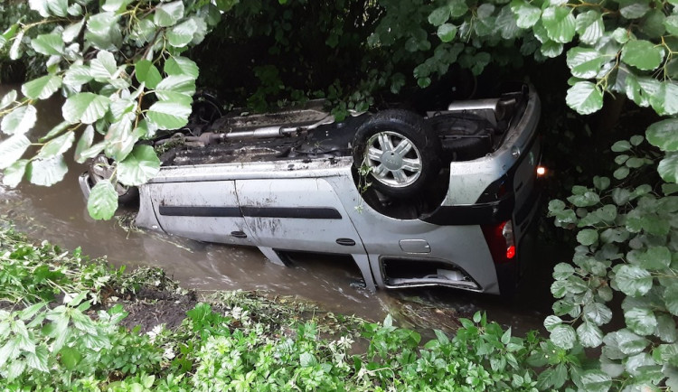 Na mokru se bouralo. Auto v Dubé se převrátilo do potoka