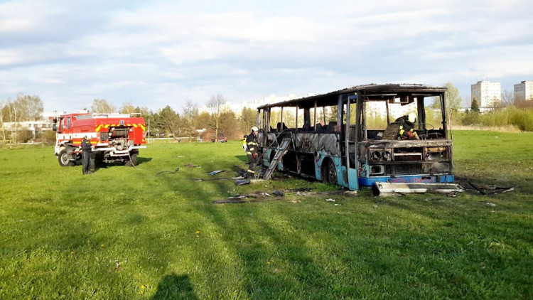 Požár vraku autobusu na louce u Vltavy v Českých Budějovicích