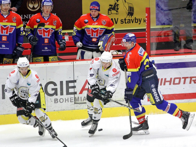 Vlastimil Dostálek se dere dopředu přes dvojici kadaňských hráčů